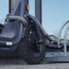 gray shackle lock textile extension secures scooter with shackle lock to bike stand
