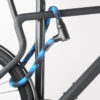 Bikes rear wheel and top tube connected to bike stand with blue and black textile rope lock